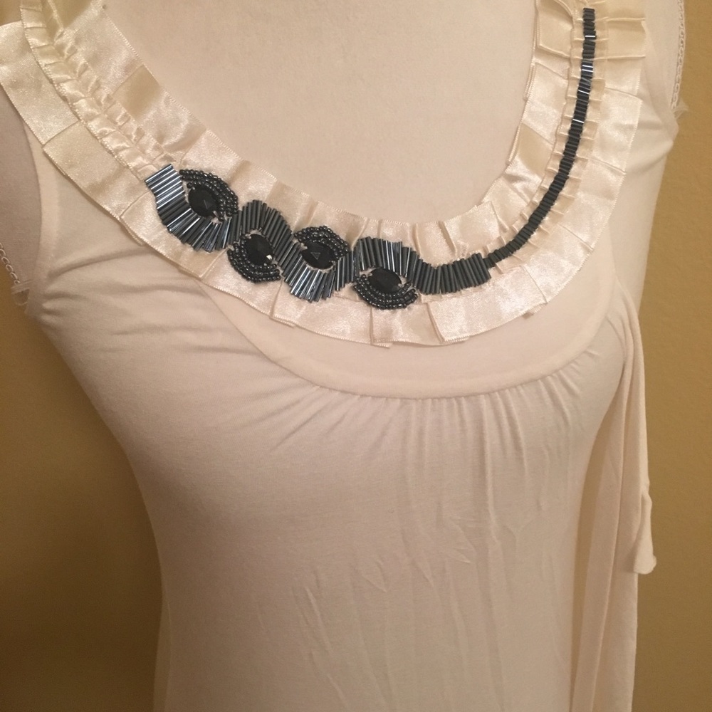 Cream sleeveless top with beaded neckline
